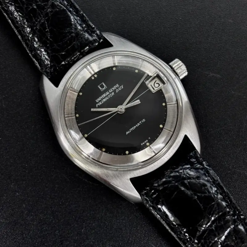 Vintage Universal Genève Polerouter Date with a black dial, silver outer ring and date window at 3 o’clock on a black strap