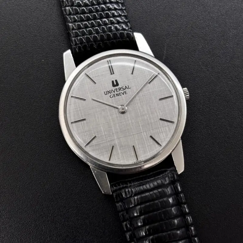 A vintage Universal Genève watch with a linen dial